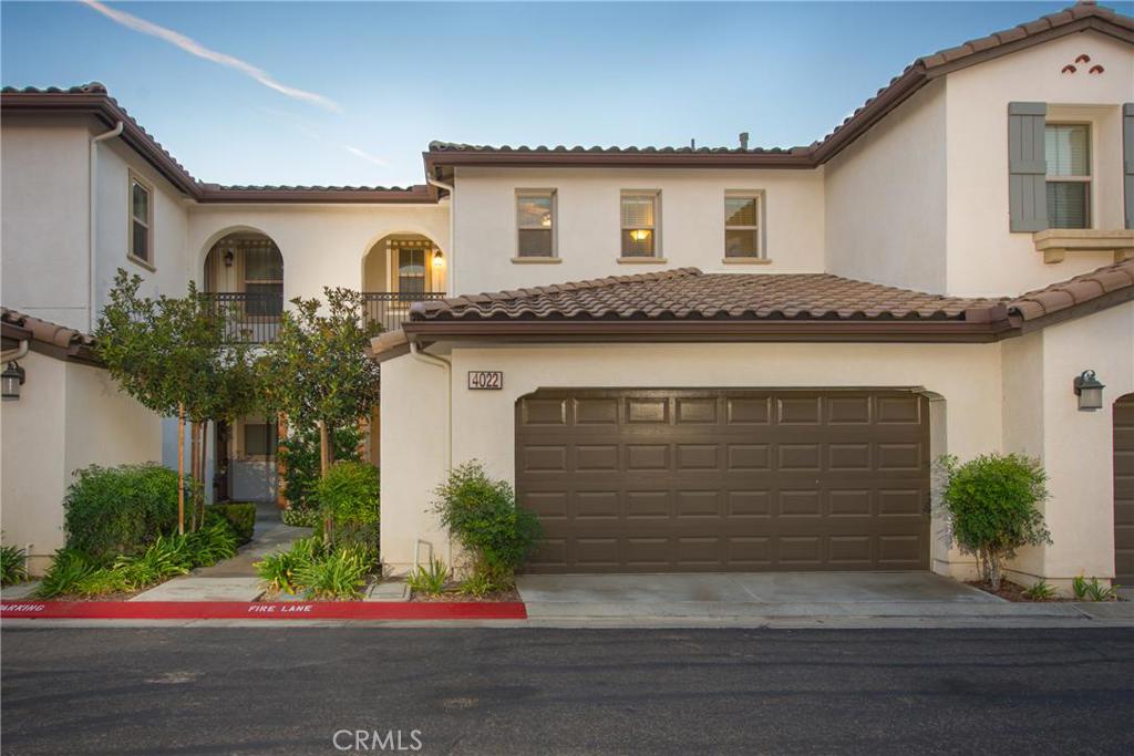Located in the highly desirable community of Villaggio, is this gorgeous residence in excellent condition. this move-in ready town home includes, an updated gourmet kitchen, and an open spacious living area perfect for entertaining. Upgrades include: Travertine tile flooring, crown molding and tall baseboards. The kitchen is highlighted with granite counter tops, stainless steel appliances, custom tile back splash, recessed lighting, plenty of cabinet space and a large center island. The bright and open floor plan offers a spacious living room and dining room combination. Access to the large private patio is through sliding doors just off the main living areas. Two bedrooms upstairs have high ceilings, newer ceiling fans and sizeable closets; the master bedroom has a large walk-in closet. The master bathroom offers a large tub, separate stand-alone shower and dual sink vanity. Conveniently located upstairs is the laundry room. The attached two car garage is another plus to this home. Enjoy the resort style amenities including pool, spa, kiddie pool and tot lot. Only minutes from Yorba Linda distinguished schools and walking distance to the new Yorba Linda High School.