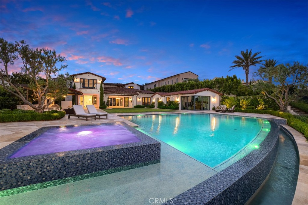Sipping wine, sharing special moments, or simply relaxing and enjoying the ocean view. The possibilities are endless at this luxurious Crystal Cove estate, where a massive homesite of nearly 25,000 s.f. complements an equally impressive residence. Grounds are among the largest in Crystal Cove and are ideal for gatherings of all sizes, with a vanishing-edge pool, a spa, a cabana with bar and grill, a fire pit, sprawling lawn, and ocean, Catalina Island and sunset views. A detached view apartment is fully contained, making it ideal for guests. Bright whites and light wood flooring create a relaxed vibe indoors, which is home to a formal entry with updated staircase, a great room with loggia access, a separate media room with entertainment center and surround sound, 6 ensuite bedrooms and 6.5 baths. Approx. 7,028 s.f., the two-level floorplan allows ample room for a chef-inspired kitchen with white cabinetry, top-of-the-line stainless steel appliances, an island, farmhouse sink, pantry, casual dining room and quartz countertops. A second-level bonus room features an additional entertainment center and a built-in desk, and the 4-car garage features custom cabinets and epoxy flooring. Slide-away glass doors and an array of balconies, decks and patios blur the lines between indoors and out. For ultimate indulgence, the primary suite reveals an ocean-view deck, built-in media cabinetry, and a fully remodeled bath with heated floors.