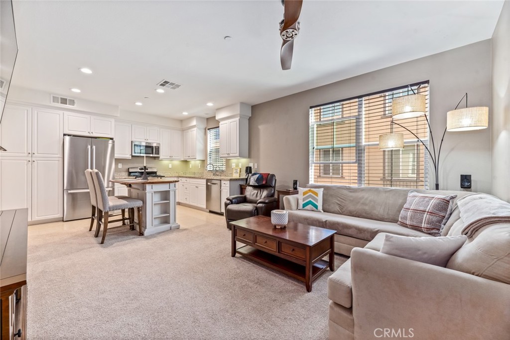 Don’t miss out on this amazing opportunity to own a beautiful home in The Ridge in Mission Viejo. As you enter the home, you are greeted by an elegant entry with custom paint, high ceilings, and extra-tall doors. The first level offers plenty of space for an office or sitting area plus easy access to a large closet with ample storage space. Across from the entry you will find direct access to the oversized one-car garage with plenty of room for storage and the tankless water heater. There is also an assigned carport for this home. The second floor features a bright and open great room which includes recessed lighting and huge windows that flood the room with light. The lovely kitchen includes lots of storage including a large pantry, granite counters, Bosch refrigerator and dishwasher, GE stove and microwave and under-cabinet lighting. The free-standing kitchen island is also included in the sale and provides additional storage and seating opportunities. The powder room is conveniently tucked away in the corner. The third floor takes you to the inside laundry on the landing where you will find a stacked washer and dryer making laundry a breeze! The over-sized master bedroom is complimented by a massive walk-in closet with custom built-in storage. The spacious ensuite master bathroom features a soaking tub and shower combo plus tons of cabinet and counter space. Other features in this amazing home include CAT-5 wire, key-less entry, ceiling fans, custom paint, new LED lights & dimmer switches, filtered water in kitchen, garage wired for 60 amp EV charging. Residents in The Ridge community enjoy access to a gated pool & heated spa, barbecues, outdoor fireplaces, a playground for kids. The community is located just a stone’s throw away from Target and all local amenities including local restaurants and shopping plus offers easy access to local freeways.