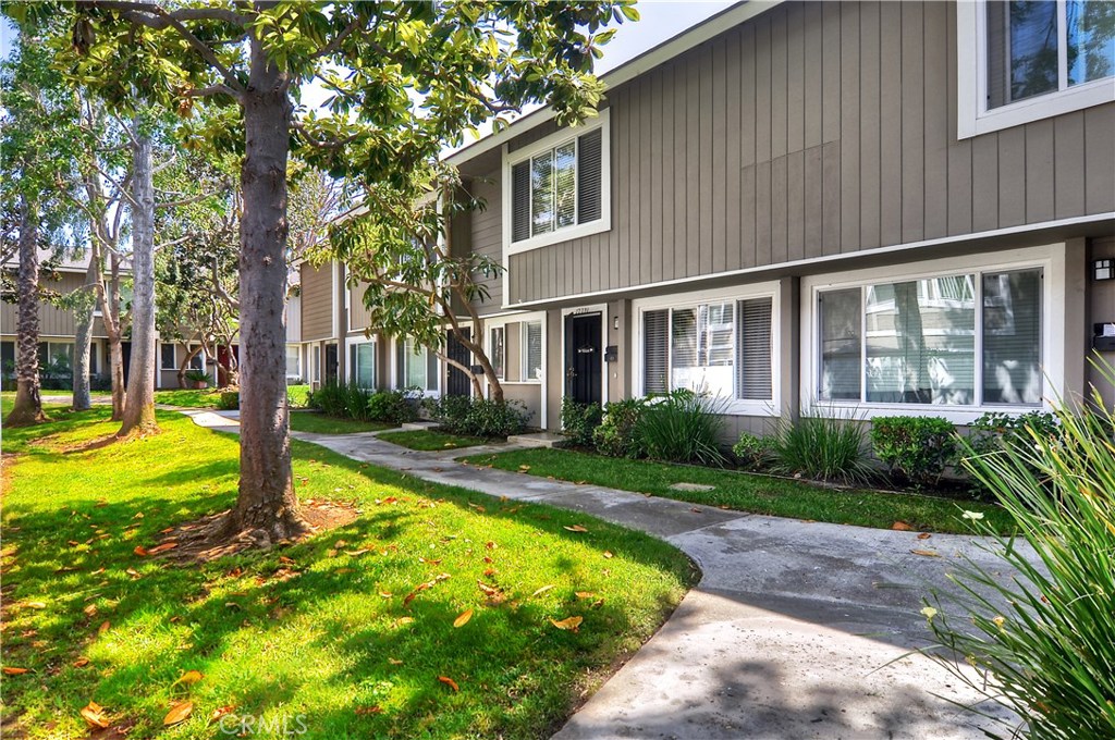 Beautifully upgraded and conveniently located to offer a living experience marked by privacy, this charming two-story townhouse promises exceptional value, not to mention close proximity to the world-renowned beaches, culture, shopping and dining that make the area special. Spanning a total of three bedrooms, the home features a spacious living room, a separate dining area, a laundry room, and a quiet back patio that’s surrounded by trees. Tranquil views of the adjacent greenbelt are one highlight of its master suite, which also boasts a crisply remodeled tile-clad bathroom. Smooth ceilings create a distinct sense of modern elegance, while ample windows allow for an abundance of warm natural light to spill in throughout the residence. Located in the community’s back row of homes, the property feels peacefully secluded—yet it still offers easy access to a shared pool. Perhaps best of all, association fees are only $245 per month. Nearby parking in a covered carport ensures convenience and practicality, completing this exceptional home.