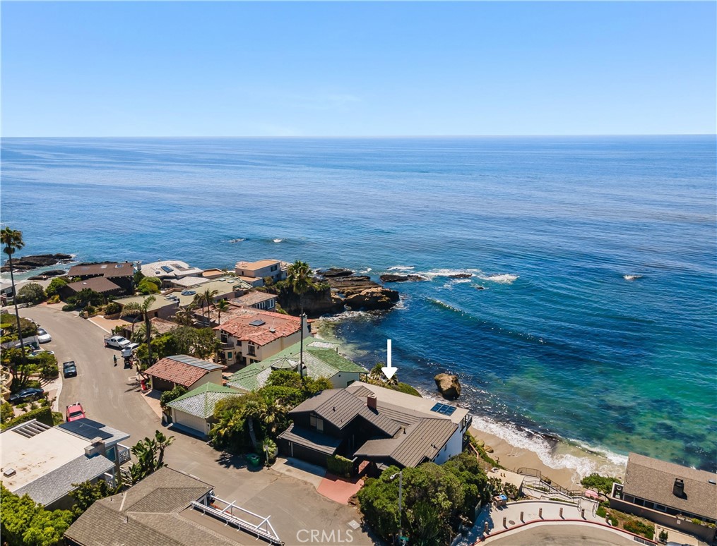 For the first time in more than 50 years, the home at 1811 Ocean Way is available for purchase. Opportunities like this rarely come on the market. Situated above Pearl Street Beach, the privileged position of the home provides vast panoramic ocean views, Catalina Island and year-round sunset views, and a prime view of the ‘arch’ of stunning Arch Cove below. The potential of the property is incredible, providing an ideal canvas to bring your vision to life. Almost every room looks out to the sea, and three ocean view decks and a sheltered private courtyard grant an incredible opportunity for outdoor living – this is the ultimate beach-lovers dream location! Ready for your customization, the versatile four-bedroom floor plan appeals to those looking for a primary residence or a secondary beach retreat. The heart of the home is a main level great room looking directly out to the open sea, anchored by the dining room and kitchen on one end and two bedrooms on the other and a deck that spans the width of the house. Upstairs is an ocean view office with a private view deck and powder room – perfect as a fifth bedroom if needed. Downstairs are two more bedrooms with additional outdoor space. Conveniently, access to the sand via Pearl Street is immediately adjacent to the property. Situated in one of Laguna’s most iconic neighborhoods, you’re still less than a block from fantastic eats and the boutique shopping and cultural attractions that make Laguna Beach a world-class destination. Take a breath and enjoy life – experience the embodiment of California coastal living at its finest before this rare opportunity disappears.