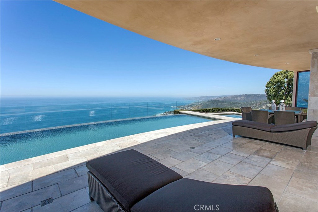 One of the most stunning coastal properties in Orange County and possibly the best home for privacy and ocean views...the 'premier location' in the gated enclave of 'Pinnacle at Monarch Point'. This home has it all, from gorgeous ocean view infinity pool, to Catalina sunsets, night lights of Laguna, and majestic, unobstructed WHITE WATER views of the coastline from South Laguna to Palos Verdes. There are no rooftops in sight, and owners enjoy complete privacy from the other homes in the area. Exceptional in design and ease of living with back yard and terrace like a private resort. Pool, spa, built-in barbeque, fire pit and fire place all for enjoying the gigantic coastal and canyon views. Travertine floors throughout (except bedrooms), movie theater, temperature controlled wine cellar, and huge "great room" with 48 feet of sliding glass for indoor/outdoor living. Zoned air-conditioning and heating system makes for the ultimate in comfort for the fortunate owners of this spectacular property. There is also a beautiful paneled library/office. You will never want to leave.