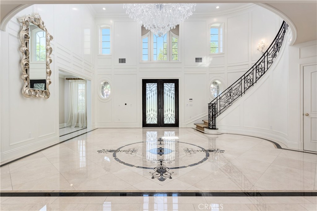 A once-in-a-lifetime opportunity to own this custom, luxury home in Arcadia's exclusive Upper Rancho area. Award-winning school district and in close proximity to Arcadia mall, parks, retail stores and restaurants. Upon entering the wide circular driveway, you will be blown away by the sheer presence of this magnificent luxury estate. This 12,011 sq. ft. 7 bed, 8 bath stunning customer home situated on a large 46,738 sq. ft. flat lot, with an expansive backyard that features privacy yet entertainment: custom swimming pool, lighted full size tennis court, custom fish pond with landscape features, outside BBQ, and wide patio area. The extraordinary home was greatly remodeled in 2014 with upgrade cost in the millions such as grand entryway with high ceilings, a double staircase at the main entrance, an elevator, home office/library, gourmet chefs's kitchen with top of the line appliances, a cinematic screening theater, sauna, steam room, and more. This is truly one of Arcadia’s best estates. A must See!