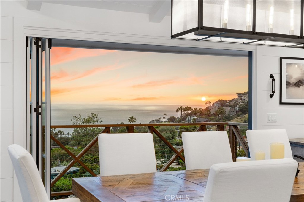 Meticulously redeveloped six years ago, this residence features an upscale modern farmhouse aesthetic, breathtaking 180-degree ocean views from every room, and a newly built ocean-facing pool, hot tub, and entertainment deck. Perched in the quaint community of South Laguna, 31561 Mar Vista Avenue offers a rare blend of coastal luxury and casual comfort. The home's interior embraces high design and modern amenities, with an open floor plan, vaulted ceilings, engineered wood floors, exposed brick accents, shiplap walls, and a gas fireplace enclosed by Austin Stone. On the main level, a chef’s dream will come true when they cook as the sunset fills the kitchen, which features Thermador professional line appliances, quartz countertops, a wine fridge, a large island, and a convenient pot filler over the stove. From the kitchen, French doors lead to the large front patio while fully retractable doors open to an ocean-facing deck. On the lower level, the primary suite has a spa-like bathroom and a large walk-in closet. This level also includes a guest bedroom with an ensuite bathroom, an additional guest bedroom, a full bathroom, and a laundry room with a sink—all with ocean views. Entertain effortlessly with the $1 million+ Austin Stone trimmed pool supported by caissons, which took over five years to complete. The outdoor entertainment area is coupled with a retractable TV that comes out of the deck and a fire pit. Pool parties and movie nights can finally be enjoyed at the same time! The lot is adorned with olive trees, California pepper trees, Mexican feather grass, and offers a beautiful private sanctuary for relaxation and enjoyment. This residence also features multiple living areas, a new roof, direct garage access, recently replaced the sewer line, and Control4 smart home technology with multiple-zoned sound systems and Josh.AI voice command capabilities, elevating the living experience to new heights. Come experience the epitome of Laguna Beach living in this exquisite home. Conveniently located between West Street Beach, Table Rock Beach, and Thousand Steps Beach, near hiking trails, shops and restaurants, Downtown Laguna Beach, and the Dana Point Harbor.