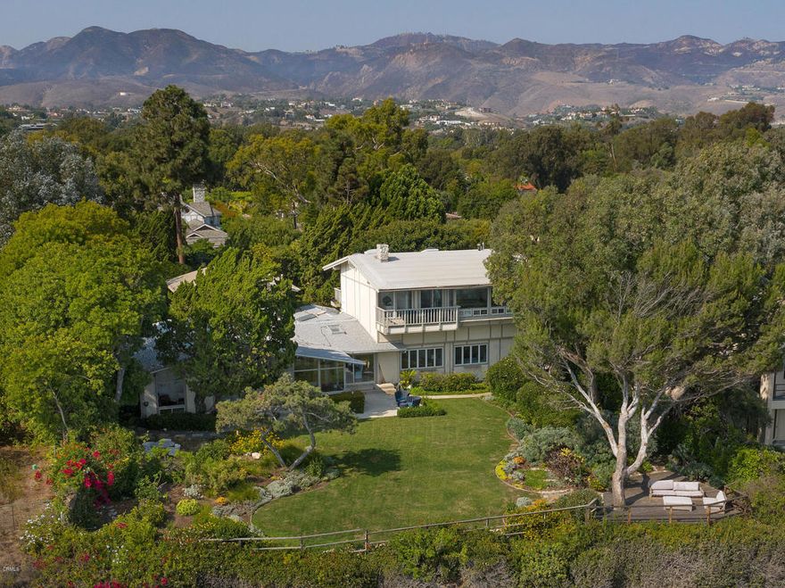 This rare coastal Malibu estate sits on a quiet cul-de-sac in the exclusive enclave of Point Dume. It features ocean views from nearly every room of the house, including Catalina Island, and an ultra-private yard along the cliffs above the Big Dume wave breaks. The scenic environment is both magical and elemental, including exclusive, gated access to miles of beach. This property offers a luxurious, active and private lifestyle, where natural beauty is front and center. The great room takes full advantage of the epic views: high ceilings, glass walls and skylights bring sea and sky into every moment. The open floorplan connects the great room, living room, dining area, wet bar and chef's kitchen. The main floor has two bedrooms and a study. Natural stone decorates walls and fireplaces, and there are wood floors throughout. The second story is a dedicated master suite with lavish baths, custom closets, 2 decks and picture windows displaying Malibu's legendary coast. Mature gardens with specimen trees grace the acre of prime oceanfront grounds. Also included are a guest house with kitchen and a studio above the two-car garage. Embedded in the serene landscape are a pool, spa, and multiple seating areas with views that stretch from Point Dume to Santa Monica.