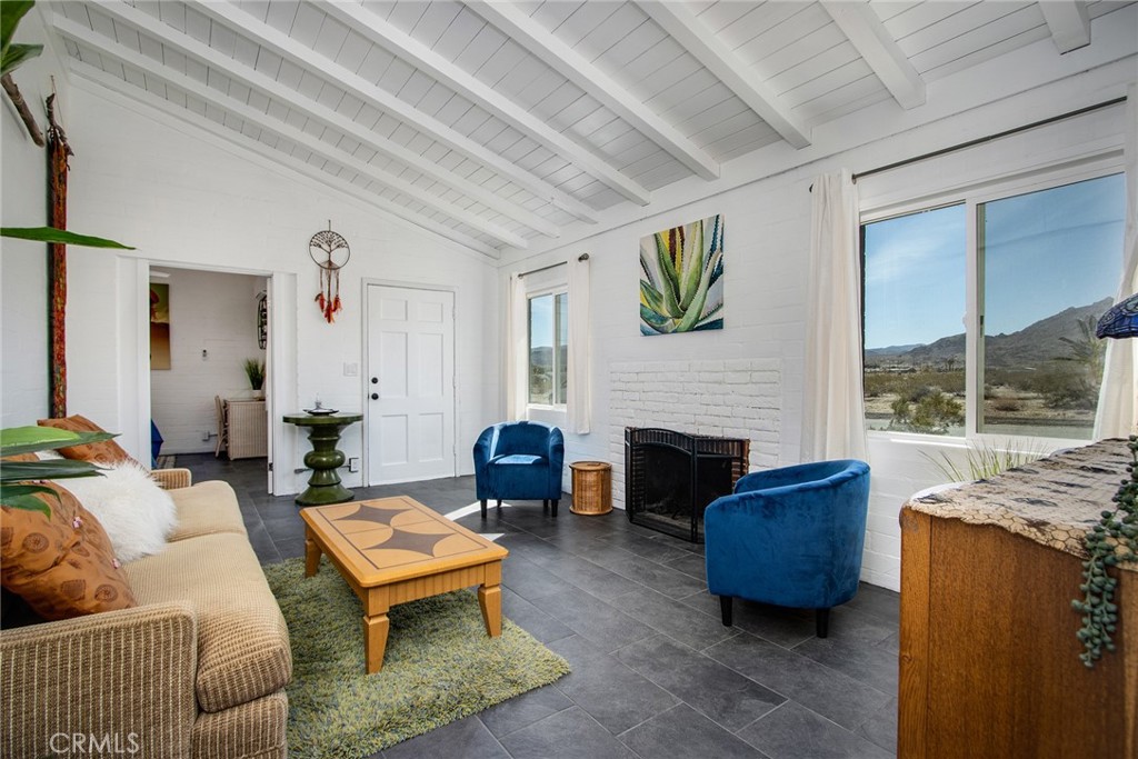 Authentic Mid-Century Modern (1950) block home with vaulted, open-beam ceilings. Panoramic Mountain Views of Joshua Tree National Park. Fully remodeled and upgraded: ALL new interior copper plumbing, water heater. Upgraded electrical panel. New tile floors throughout. Floor-to-ceiling subway tiles in bathrooms. Kitchen also has floor-to-ceiling subway tiles and industrial stainless-steel appliances and shelving. Zoned, ductless mini-split AC/Heating. Fireplace in living room for warmth and ambiance. Indoor/outdoor dining and living spaces. New hot tub. Hike out the front door and across the open desert, or wander through the neighborhood to nearby downtown dining. The $20 million Project Phoenix downtown revitalization project and its new Freedom Plaza has helped make 29 Palms the new go-to area, with better infrastructure and more dining/drinking options than even its more famous neighbor – Joshua Tree – to the west. A new beer brewery recently opened in the revitalization project area, alongside the thriving Farmers Market and Grnd Sqrl – and established gastropub – and more pubs and dining options are underway, creating a burst of energy in the area, similar to the energy in Silverlake and Echo Park when they began to gentrify and revitalize years earlier. 29 Palms is still in the nascent stages of the fantastic city it will become and this is your perfect opportunity to become a part of this exciting new community.