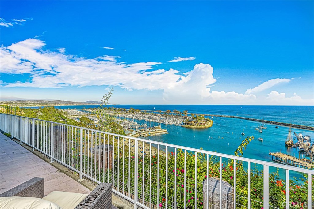 Resort living at it's Best! Stunning Ocean view condo is located on the main level perched on the bluff of the Dana Point Harbor. This turnkey property has the look and feel of a tropical resort both inside and out.
This condo offers incredible ocean views from the living room, kitchen and master bedroom. The unit is just a few short steps to the immaculately maintained gardens, heated pool and spa and conveniently close to the clubhouse.
The intimate gated community has only 34 units and is walking distance to all of downtown Dana Point, Dana Point Harbor and the coastal cliff pathway to Strand Beach. The gated subterranean parking with two assigned spaces and some storage is directly below the unit. Looking for big ocean view single level?
You found it!