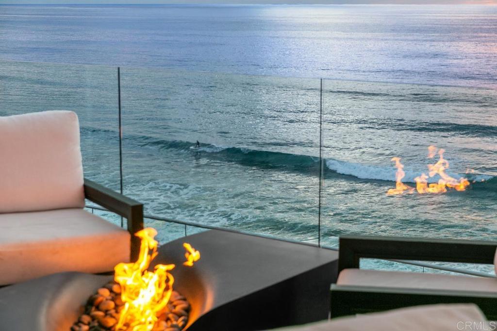 Welcome home to 1496 Neptune Avenue in Encinitas…the coveted street’s most spectacular oceanfront property with pristinely private beach access year round. Entirely remodeled in 2020, this approx. 3000 sqft stunner boasts all new electrical, plumbing, interior and exterior walls with elegant designer finishes and upgrades throughout. Professionally and impeccably maintained lighted stairs with ocean flood light and sound system, plus coastal commission compliant seawall, bluffside yoga deck, convenient beachfront storage, upper and lower gates for optimal safety and security. Through the authentic tibetan front gate and inside the privacy of a powder-coated stainless steel automated car gate, a fully enclosed front courtyard boasts a world-class Koi pond, specimen plumerias, custom glass 2-car garage door, stunning Santa Barbara exterior finish, triple tile roof, copper rain gutters and gorgeous new walnut and frosted glass front door. Stunningly upgraded throughout with radiant heat flooring, 2 interior and 2 exterior fireplaces, fully automated sheer and blackout blinds, Lutron lighting system, Yamaha interior and exterior audio system, walnut doors, Toto toilettes, custom storage and built-ins, and never ending ocean views. The entry floor offers Marble Flooring, Professional Chef’s Kitchen with Mia Cucina custom cabinets, Subzero refrigerator/freezer, wine refrigerator, Bertozoni 6-burner gas range + griddle and steam oven, guest bedroom with ensuite bath, plus additional oceanfront bedroom and full bathroom with custom Mia Cucina cabinets and hand-painted lotus tile, plus beautifully functioning elevator to the upstairs primary retreat. Upstairs, the primary suite with Porcelanosa flooring with radiant heat, exterior and interior fireplaces, vaulted ceilings, panoramic ocean view plus 2 separate adjoining decks. Stunning bathroom suite with steam shower, designer tile, extra large bath tub, dual sinks, vanity, walk in closet with built-ins. Breathtaking oceanfront gym with folding Anderson glass doors, and side sliding glass window. Lower level offers a separate guest suite complete with kitchenette, luxury full bath, ductless heating and air, Scotsman Ice Maker. Expansive under-home storage, including housing two tankless water heating and in-floor heating systems. Large exterior decks with Tucci automated umbrellas, custom canopy, and deluxe standing jacuzzi. THIS HOME IS A MUST SEE!