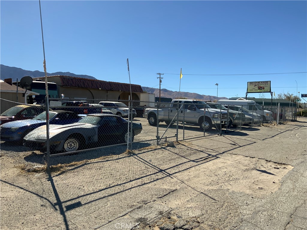 This property, currently licensed as a car lot, offers endless opportunities for various businesses. You can even build a home on the back portion and run a business upfront. Property includes 1.03 acres of fully fenced land , rolling gates, two offices, two large storage rooms, a metal garage with a rollup door, and covered storage. the possibilities with this location are vast. the property's value will appreciate with upcoming l0cal growth.