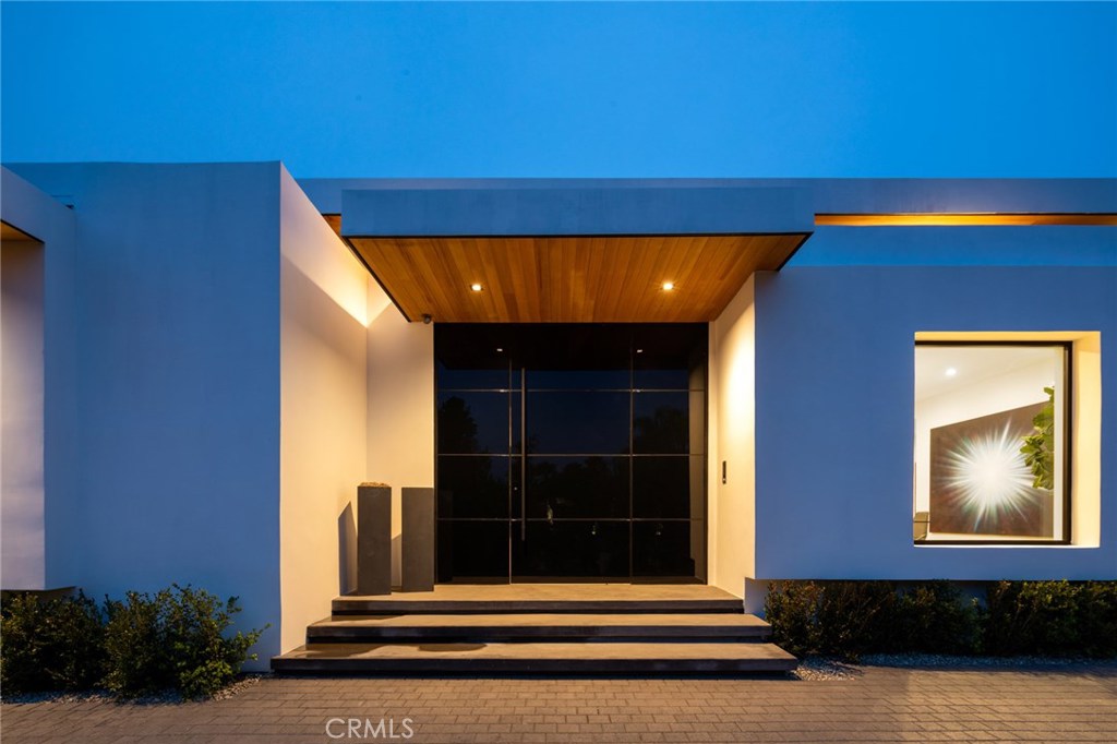 The epitome of the California contemporary lifestyle has arrived with this example of state of the art design and execution in 10011 Lawrence Lane. Discover every square inch of careful detail throughout this 5,472ft residence on a 13,444ft piece of sought after earth. Situated in the coveted Beverly Hills School District, and mere minutes from the world famous Beverly Hills hotel, is a newly built architectural masterpiece that maintains its original footprint of the residence built in 1969, in essence awarding voluminous width to the eye. Volume was the flagship element to capitalize on the airy space with multi elevated ceilings beginning with 14ft as you enter into the home and its formal living and family areas. 12ft Fleetwood doors go in the walls to create the dream indoor/outdoor space. The kitchen also has it's own fleetwood windows that open up to a bar for outdoor seating. Miele appliances top off the gorgeous kitchen. The other flagship design element is a 14 foot, double sided fireplace with 16 slabs of marble, perfectly bookmatched to create a true sculpture of timeless art. Tucked away is a guest/maids quarters or office above the garage, with the rest of the home sitting on one level. The outdoor space in the backyard holds a 50ft lap pool, and hot tub that holds 6-8 people. World class design in a world class location await.
