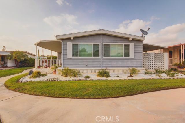 Located by a lustrous green belt, this corner 1600+ sqft, 2 bed 2 bath immaculate senior mobile home is breathtakingly beautiful with amazing views with easy access to club house, pool and other amenities. Over $30,000 of upgrades including new landscape, new roof, new gutters, new water heater, new front and back door, new slider and light by the patio, new windows with plantation shutters, new wood flooring, wall paper and paint througout, new fan with lights in dinning area and living room, new hood fan and gas top, new kitchen and bathroom facets, new toilets and light fixtures, new mirror in guest bathroom and new custom closet in master bedroom from closet world. All this for only $95k. Grab it before it is too late!