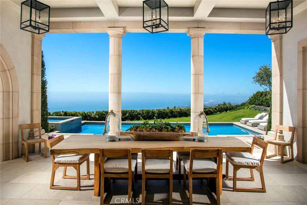 From its perch on the highest point in Newport Coast, this new custom estate is a tale of 2 worlds: The magnificent Mediterranean inspired exterior leading to a crisp transitional modern styled interior.
The main entry level boasts soaring ceilings and a captivating living space merging indoor and outdoor living into one. With the push of a button the magnificent electronic pocket doors let the outdoors in and the indoors out. The kitchen is ideal for the culinary-minded with professional appliances, two islands, and a sun-splashed breakfast nook all very open to the gigantic great room with dual televisions. In addition to the profound open space, you will find a lounge, bedroom suite, powder rooms, library, and a contemporary wood panel office.
The upper level with four generous bedroom suites and great bonus room, also boasts a tremendous master suite with spacious and elegantly appointed, separate baths and closets all of which offers unbeaten 180 degree views of Catalina Island, Newport Harbor, beaches and of course, the sparkling Pacific Ocean.
The subterranean entertainment level is a thing to behold, bringing a stunning visual display of luxury. The wine cellar is on full display from the billiards room and bar area all adjacent to the stadium style theater. Nothing is left out, with garaging for 8 cars and elevator service to all 3 floors rounding out this very special property.