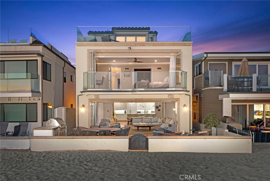 Welcome to 4807 Seashore Drive, the ultimate beach house situated in the heart of West Newport. Sitting directly on the sand with ocean views from every look out this non-boardwalk location makes it exceptionally private and quiet. This wonderfully functional residence encompasses 5 bedrooms and 4.5 bathrooms and a gym. The main level boasts an open concept kitchen, dining room, and living room with La Cantina doors that open to the spacious front patio complete with a BBQ, fire pit, and dining table, giving it the ultimate indoor-outdoor living experience. Top of the line Thermador appliances, a center island with prep sink, quartz countertops, two additional refrigerator drawers, ice maker, ample cabinetry, and a walk-in pantry complete the chef's kitchen. The second level consists of a spacious master suite with a large sitting area, fireplace, and a wall of bi folding doors that capture unbelievable ocean views with a deck to enjoy the sounds of the waves crashing. The master bath includes dual vanities, a walk in shower, jetted soak tub and an oversized walk in closet. Two ensuite bedrooms that open to an outside deck space with jacuzzi complete the second floor. The third floor currently features two additional bunk rooms and a gym with La Cantina doors opening to a generously sized entertaining deck with panoramic views of the whole peninsula. Complete with a two car garage, this is truly a great opportunity to own at one of the finest beaches and surf spots in the world!