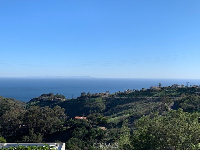 This property listing paints a picture of a rare opportunity for potential buyers looking to build a home with ocean views in a peaceful part of Malibu. Here are some key highlights:
Property Details
Location: Santa Monica Mountains, Latigo Canyon, Malibu, with proximity to Pacific Coast Highway (PCH)
Size: Two adjacent lots totaling 10,138 sq. ft. (5,231 sq. ft. and 4,907 sq. ft.)
Potential Uses: Ideal for a single ocean-view home or a duplex
Water and Utilities: Las Virgenes Water District with a fire hydrant on the street
Views: Ocean views, including Catalina Island
Lot Features: Quiet, tranquil setting
Considerations
Due Diligence: Buyers are encouraged to verify property lines and perform their due diligence TOPA IS AVAILABLE
This parcel could offer the perfect blend of natural beauty, privacy, and accessibility for buyers interested in creating a custom home with panoramic ocean views in a serene mountain setting