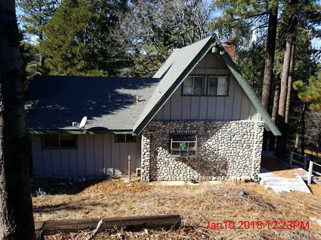 Looking to be close to Lake Gregory and in the coveted San Moritz area, but thought it was out of budget? Take a look at this large, 3-story home! The main/entry level has an open concept living area with a deck, multiple sliding glass doors, fireplace, and incorporates the kitchen and dining area. There's also two bedrooms and a full bath just off the living area. Upstairs is an oversized loft that looks down into the main living area and also takes advantage of the vaulted ceilings and natural light coming in through the windows. The lower level is a family room plus a master bedroom with an attached 3/4 bath. Even though the house is downslope from the street, there's a flat yard area both in front and in back. The ambiance is warm and woodsy, with light colored pine and tongue and groove throughout, with accents of gray river rock. This home needs some work - that's why the price is so great!
