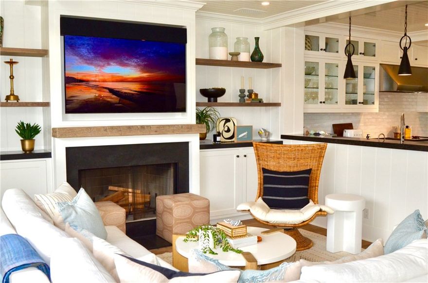 Perfectly appointed in Balboa Peninsula's prestigious Peninsula Point neighborhood, this Cape Cod-inspired home has been beautifully renovated to achieve the perfect blend of coastal living with upscale entertaining.  Taken down to the studs and completely rebuilt in 2014, quality craftsmanship is found in every nuance and detail of the home.  Top-of-the-line finishes adorn each room, from the 60-inch Wolf range, Miele dishwasher, Sub-Zero refrigerator, 147-bottle Sub-Zero wine refrigerator, to the Carrera marble island.  Featured in the adjacent butler's pantry are a 2-drawer Sub-Zero beverage refrigerator, and stainless-steel pasta filler. Seamless indoor/outdoor living is achieved through a trio of sliding doors from the front patio to the central courtyard, complete with built-in Wolf grill and newly-designed outdoor shower.  The bright and open kitchen, living, and dining rooms serve as easy gathering spaces. Elegance is defined in the lavishly beautiful powder room, with generous laundry room and direct-access garage completing the main floor. The 2nd level is as functional and impressive as the rest of the home with newly-designed sleeping quarters by renowned Heirloom Decor, completed in 2023. Each of the 4 bedrooms has been thoughtfully reimagined with calming, coastal-inspired colors and textures in paint and wallpaper, rattan shades, and new fans, with 2 additional bathrooms found on the 2nd floor. Luxury meets comfort in the primary en-suite, featuring a welcoming fireplace, generous walk-in closet with custom cabinetry, and private balcony to soak-in sun-dappled mornings.  The spa-like bathroom retreat is luxuriously appointed with Carrara marble steam shower, towel warmer, and dual Carrara marble vanity. Gather the family for game and movie nights in the 3rd floor entertainment room custom-designed with built-in cushioned seating, Sub-Zero wine refrigerator, and newly-designed bathroom. Or, reimagine the space for additional sleeping options.  Unwind amidst balmy coastal breezes and picturesque sunsets on the generous rooftop deck, seated around the charming fire pit. Just steps to the sand and world-renowned Wedge surf break, and close to iconic peninsula favorites such as the Balboa Fun Zone, Newport Pier, and Balboa Island Ferry.  With access to limitless restaurants, shopping, and great proximity to Fashion Island, Newport Beach Country Club, and John Wayne Airport, this once in a lifetime property truly is the ideal place to call home.