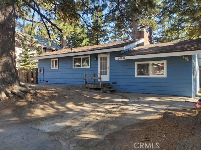 One story home, now ready for new owners in a great neighborhood of Running Springs. This very rare one story with level yard will not last long! Updated and upgraded inside and out with new paint, new kitchen, new flooring to give you that move-in ready feel. Large back deck overlooks a yard that's great for entertaining, setting up a swing set or having the dogs exercise. Situated on a flat, county maintained road, just two blocks off the highway making access a breeze in any weather. Two bedrooms plus a den or game room. Open concept kitchen/living room with vaulted ceilings and lots of natural light is very welcoming to bring people together. Wood burning fireplace to keep things cozy and warm. Don't delay seeing this gem; it's not going to last in today's market!