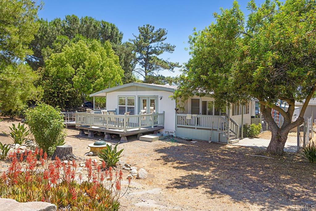 1983 MANUFACTURED HOME THAT IS BEAUTIFUL AND MOVE-IN READY!! - Offered for $220,000!! 2 Bedrooms, 2 Baths remodeled home that is just gorgeous inside and outside. A brand-new A/C system was just installed. The home has a handicapped ramp that is negotiable. This home is very private with a greenbelt area to the right of the home, a large yard, and a lovely view of the mountains. The living room opens up to a nice deck that is perfect for BBQing or just relaxing and enjoying the natural surroundings and wildlife. It offers a large living room plus a family room or den. The master bath has a large walk-in shower. This home is located in beautiful Skyline Ranch Country Club, a premier Senior Park that sits in the foothills of Valley Center. FREE golf to all residents, full clubhouse use, gym, gated community and much more. Skyline Ranch is a land leased park; the monthly space rent here is 1600.00. Please come and see this wonderful home located in a great Senior Park with many amenities.
