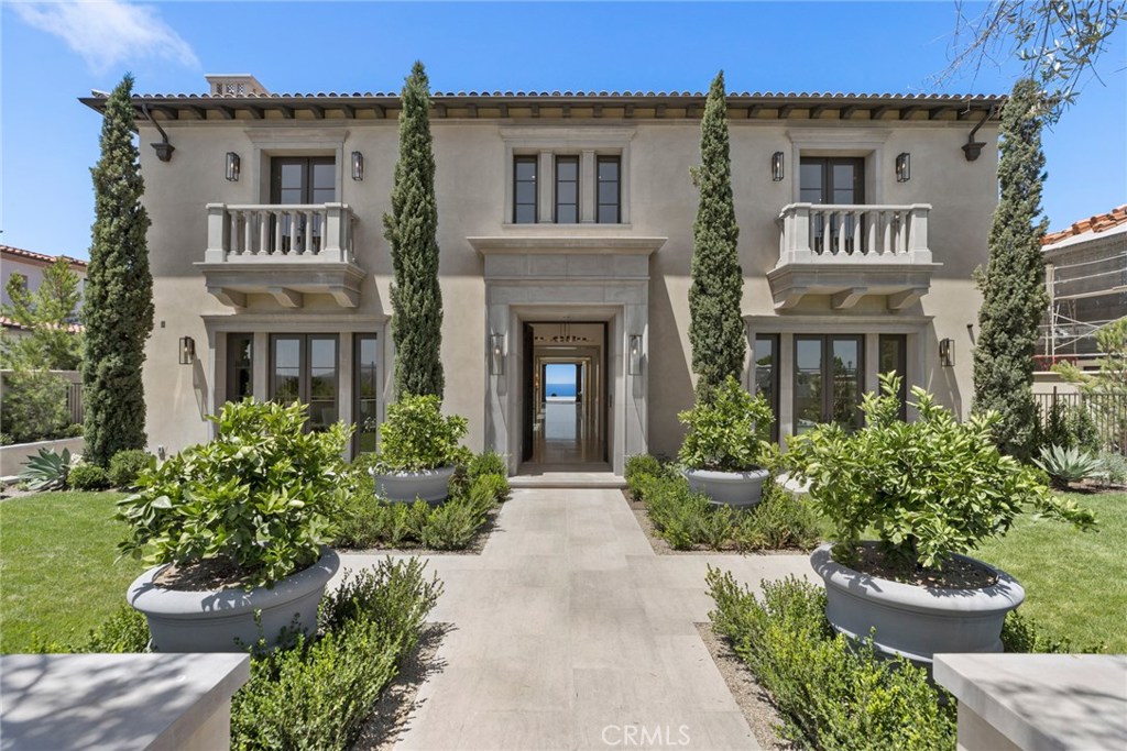 This new contemporary estate in Crystal Cove is beyond compare. Ideally situated on a quiet, single-loaded portion of a premier street, this residence boasts a 18,770 +/- s.f. lot. with canyon and ocean views from the front of the home, and ocean, harbor, city lights, Catalina and sunset vistas from the rear. Designed by Eric Trabert of E.T.A. Architects, built by renowned premium custom homebuilders Neilson Construction, with interiors by Studio Jackson Designs, there has been no expense spared in this 11,290 +/- s.f., 6 bedroom, 11 bath home. A rare 30-ft. building height allows for soaring ceilings and a 2-story sunken courtyard for incredible natural light. Open-concept livability is especially enjoyed on the lower level that opens to the central sunken courtyard and from the first level, where the main living areas open completely to the views and to the fabulous rear grounds, which include a negative-edge pool and spa, pavilion with lounge area and pool bath, and outdoor kitchen with bar. An elevator serves all three levels of the residence, which also includes a 2,800+ s.f. basement with garaging for 5 cars. Crystal Cove amenities include 24/7 guard-gated + patrolled security, tennis, clubhouse, swim + fitness facilities, playgrounds.