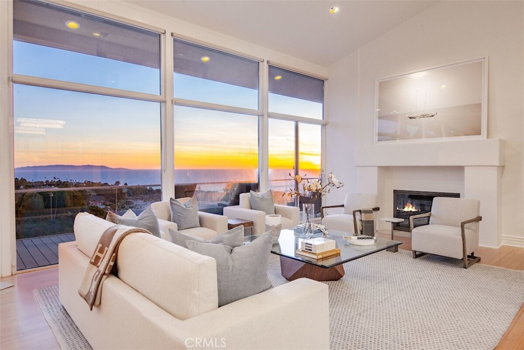 Indulge in the epitome of luxury living at 1380 Via Romero, Palos Verdes Estates. This exquisite property boasts 6 bedrooms and 6.5 bathrooms, providing an expansive 6,136 square feet of living space. Nestled on a generous 17,043 square-foot lot, this home offers a perfect blend of sophistication and comfort. Built in 2000, this residence is a timeless masterpiece, featuring unobstructed panoramic ocean and Catalina views from 5 of its 6 bedrooms. Dual primary suite options on each level offer indulgent Jacuzzi tubs, walk-in closets, and expansive Catalina island and ocean view. A retreat within a retreat, the sauna room provides a tranquil escape, and the dedicated theater promises unforgettable entertainment experiences. The property includes a 3-car garage, complemented by four fireplaces that add warmth and charm to various living spaces. The multi-zone air conditioning and heating system ensure optimal comfort throughout the year. Experience the pinnacle of culinary delight in the chef's kitchen, complete with SubZero appliances and a 48” range. Abundant natural light bathes the interior, complemented by over 10 skylights that emphasize the high ceilings, creating an airy and inviting ambiance. Recent updates to the bathrooms and hardwood flooring bring modern elegance to this luxurious abode. Storage is abundant with multiple large storage rooms, seamlessly integrated yet not included in the official living space. Step into the backyard oasis where a saltwater pool and spa, complete with a motorized cover, invite relaxation. Enjoy the privacy of low-maintenance landscaping, and revel in the dramatic exterior lighting system that adds a touch of magic to the evenings. This property goes beyond the ordinary with in-wall speakers, ensuring a harmonious atmosphere throughout. For those with furry companions, an exterior gated dog kennel provides a secure and stylish space for pets. Pride of ownership is prevalent as you tour the home and observe the TLC taken in every detail.