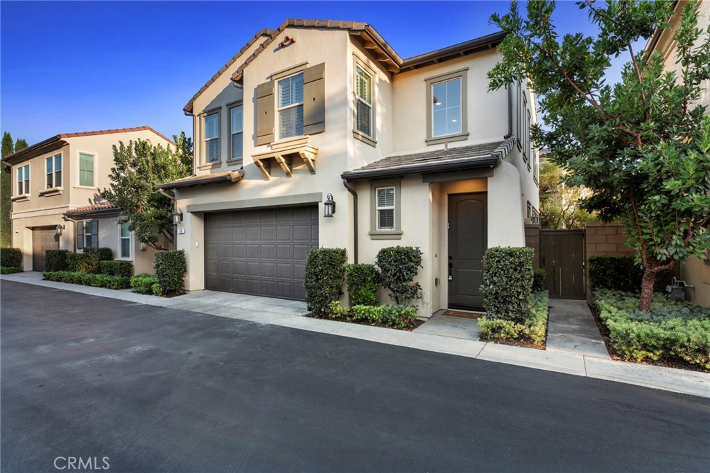 Nestled in the leafy Irvine community of Sage at Portola Springs, this professionally upgraded residence is bright, airy and move-in ready. A double-height ceiling provides a grand first impression in the entry, which displays an elegant staircase and clerestory windows. The open-concept main level is home to a great room with a wall of windows, solar roller shades throughout the downstairs and a sliding glass door that opens to an inviting private patio. At its other end, the great room flows directly to a designer kitchen with island, breakfast bar, upgraded solid-surface countertops, a convenient pantry, white cabinetry with glass uppers, and deluxe stainless steel appliances. Powered by a state-of-the-art solar system, the two-story design extends approx. 1,697 s.f. and features hardwood flooring on the first level, 2.5 baths, an attached 2-car garage with direct access and epoxy-coated floor, custom interior paint, plantation shutters, ceiling fans, fully owned water softener and drinking water filtration system. Upgraded carpet enriches the second level, where a loft showcases an office/study area with built-in desk, and 3 bedrooms include a master suite, tray ceiling, walk-in closet, soaking tub and separate shower. Served by outstanding Irvine schools, Portola Springs presents easy toll-road access and is embraced by the hills of Irvine. Highlights include bike paths, playgrounds, pools, full-featured clubhouses that can be reserved for private celebrations.