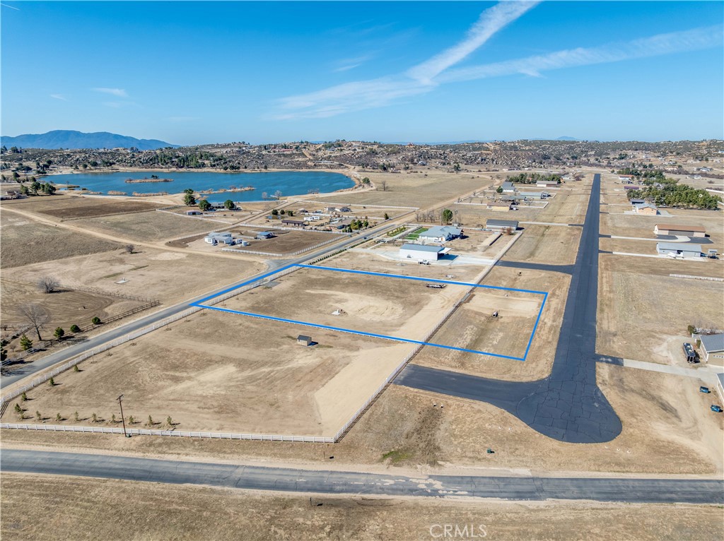 RARE and INCREDIBLE SoCal PRIVATE AIRSTRIP "AND" EQUESTRIAN PARCEL: Lot 330 On PAVED Sky Harbor in the beautiful Lake Riverside Estates Community. Enter the gated 2.69 ACRE Fully Fenced parcel offering a new PRIVATE DEEP WATER WELL WITH ELECTRIC AND PRESSURE TANK OPERABLE AND READY TO GO! AND THE BEST PART..................DIRECT TAXIWAY ACCESS TO the RUNWAY. This 3600' lighted airstrip offers residential and commercial zoning benefits, allowing for custom homes and hangars and is equipped with a VASI system. Freshly planted trees line the property perimeters and include pines, mulberries and mimosas!! Located in the heart of wonderful SoCal with mild seasonal temps and higher elevation with clear skies above the hustle of the city down below. This developed parcel is completely level, and with exception to building setbacks from the edges, it is all usable and ready for your dreams. Build your private Hangar "AND" Horse Barn, custom home, gardens, and more! Located only 25 min from Temecula for shopping and dining and approx 30 min to Temecula Wine Country. Within 45 min you can enjoy Palm Desert, Idyllwild and Julian. This gorgeous community offers a 55 acre lake for bird watching, catch and release fishing, dog walking, picnics, and BBQ areas. There is a tot lot, pool, meeting/rec room, bike pump track, sports courts, and direct access horse and hiking trails in the adjacent National Forest! The community equestrian arena is a quick 2 min ride from the parcel and the lake is only a few minute walk away! This type of real estate is quite rare throughout the US but this historic aviation and equestrian community offers it ALL!!! The local pilots have created a supportive Pilot's group where likeminded enthusiasts get together and plan great fun events like Santa Fly in, air and car shows, and runway maintenance. Many types of construction are allowed, and the owners recently built their own custom home and they are happy to share information on the process. A must see for the aviation (and equestrian) enthusiast!!