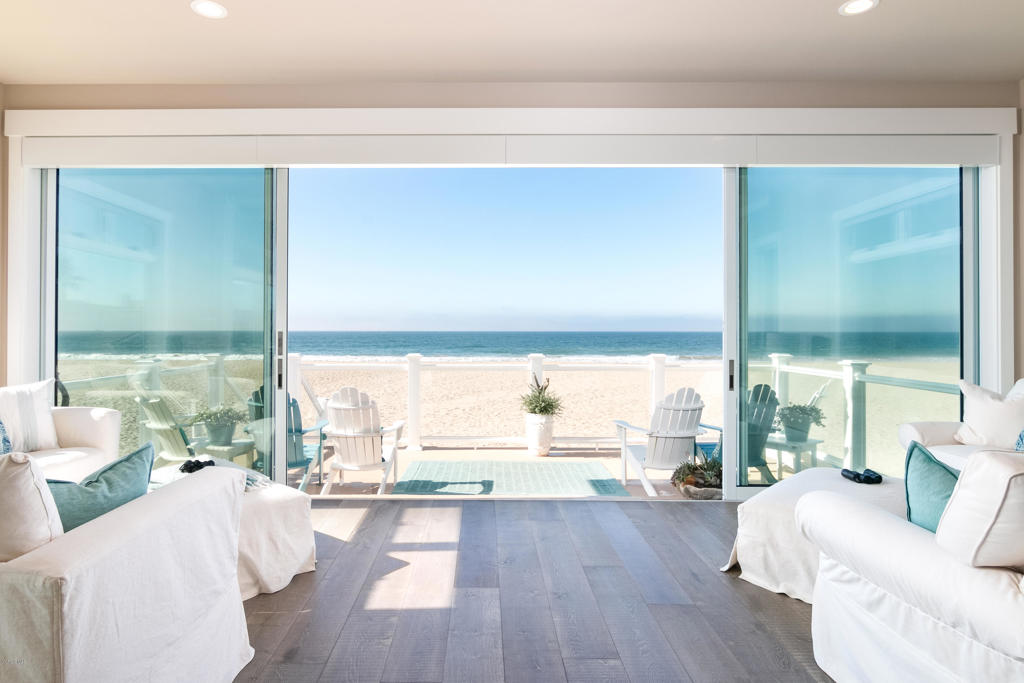 Spectacular oceanfront home with unobstructed views of the Pacific and the Channel Islands. Built in 2017, this beautiful custom Cape Cod was thoughtfully designed with entertaining and family gatherings in mind. At approx. 4888 SF, the home has 4 bedrooms and 5.5 baths, with an elevator serving all levels. A media room, game room, office & bonus room offer ample space for work and play, most with views. The great room has a dining area, gorgeous coffered ceiling, fireplace and a wall of glass that opens to a large oceanfront deck with breathtaking views! The spacious kitchen is a gourmet dream, with quartz countertops, a large center island with 2 dishwashers and a peninsula that seats 8, a Thermador Range, double convection ovens, custom panel fridge, a wet bar & butler's pantry. The master has amazing views up and down the coast. The master sitting area has a fireplace and a trifold window, which is the ideal vantage-point to see dolphins playing in the surf or watch shooting stars over the ocean. The master bath includes 2 vanities in separate spaces, 2 walk-in closets, an ocean-view tub and a large ocean-view shower. There are 3 decks total, all with views. The covered rear deck has a built-in Evo for Teppan-style grilling. A true show place!
