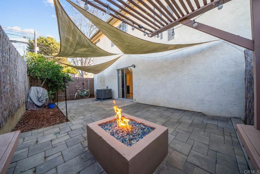 The perfect starter 3 bedroom condo in the heart of Spring Valley with a spacious and open floorplan that features a fully remodeled modern kitchen, an open backyard, finished with pavers and a cozy firepit perfect for hosting. Additional features include your very own attached 2 car garage, a powerful central A/C, custom tile flooring downstairs and lovely wood like vinyl plank throughout the staircase and upstairs. This end unit condo has so much to offer.