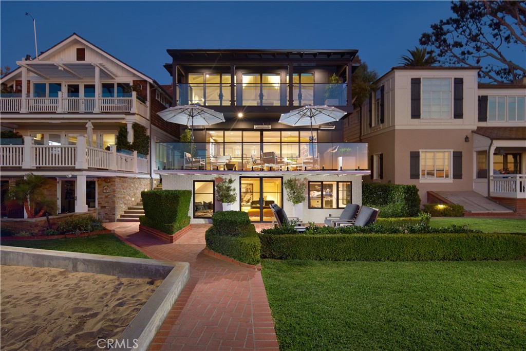 With the allure of one of Newport Beach’s most coveted and hard-to-obtain addresses, a prized waterfront setting, private dock, and an extensive remodel that preserves its timeless appeal while incorporating sophisticated modern luxuries, this Bay Island home is a genuine rarity. Destined to sell quickly, the refreshingly light and welcoming residence is 95% new and greets friends and loved ones with a covered front porch and patio. Breathtaking bay views impress from the entry, which leads to open living and entertaining spaces that include a dining room, and a great room with custom built-ins, a fireplace, and slideaway glass doors leading to a balcony with panoramic water views. Passing sailboats, awe-inspiring yachts and shimmering evening lights reflecting on the bay create a backdrop for unsurpassed Newport Beach living. Open to the great room, a chef-caliber Leicht kitchen presents a spacious island, custom contemporary cabinetry and countertops, illuminated glass uppers and Gaggenau appliances. Four en suite bedrooms and six- and one-half baths are featured throughout nearly 4,539 square feet and include a main-level bedroom and two secondary bedrooms that open to a top-floor balcony with community-garden views. Private, opulent and poised to maximize dramatic bayfront views, the residence’s primary suite beckons with a fireplace-warmed sitting area, vaulted open-beam ceiling, covered waterfront view balcony, an office, two walk-in closets, and separate baths, with one boasting a freestanding tub and a separate shower. Preferred appointments include a trio of genuine wood-burning fireplaces, which are no longer allowed in new-build Newport Beach homes, Waterworks fixtures and lighting, Belgian 12"-wide wood-plank flooring, French Zellige tile and Marble in all baths and kitchen, solid wood white oak interior doors and cabinetry, abundant storage, two secured off-island parking spaces, and a lower-level bonus room with access to the backyard, lawn and small beach.