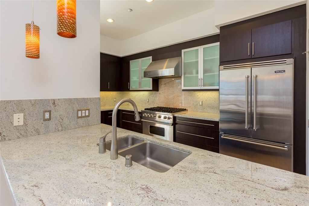 Fantastic luxury Penthouse flat located in the prestigious Lennox Mid-Rise building in the heart of the Irvine Financial District. Inside this modern two bedroom / two bath property, discover open living spaces highlighted by wide-plank distressed wood flooring, upgraded designer plush carpet, custom window treatments, recessed lighting and more. Featuring a multitude of windows for exceptional light and two over-sized viewing decks that capture the Irvine Financial District and Newport Coast hills. The Chef's kitchen includes a large island, white cashmere slab-granite counter tops, modern cabinetry and stainless steel Viking appliances. This deluxe property includes an over-sized private side-by-side two car garage. The wide open floor plan accents the alluring scenic city views. Also featuring five-star Lennox ambassador service seven days a week. The world class amenities at Central Park West include two resort-style saline pools and spas, an 8000 square foot gym and fitness facilities and a community event center. Live, work and play in what has become the hottest lifestyle location in Orange County. Convenient to Fashion Island, South Coast Plaza, UCI and John Wayne Airport. Exceptional opportunity to own a Penthouse in a highly desirable location.