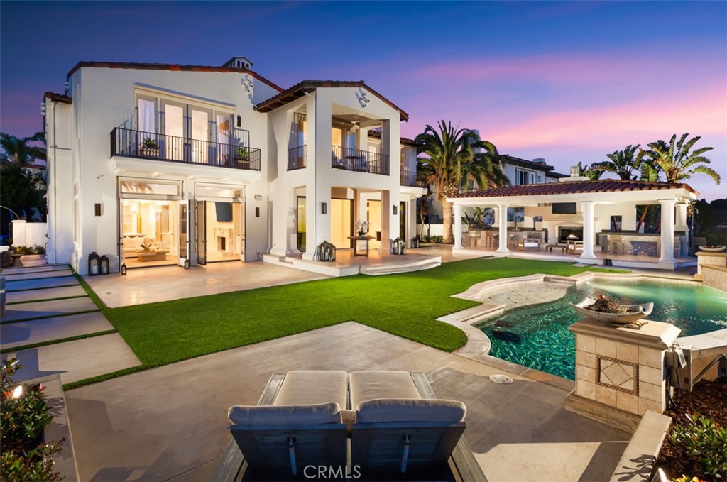 Newly re-imagined and fully renovated, 1 Via Brezza is a transitional expression of timeless elegance and modern practicality that has been meticulously remodeled; this (approx.) 5,300 sq foot residence situated in Newport Coast's prestigious guard-gated community of Pelican Heights boasts breathtaking ocean, coastline, city lights, and canyon views from a premium flag-pole corner lot. This exceptional estate offers custom designer home finishes and sits on an over-sized (approx.) 15,000 sqft lot with its own gate and motor-court. The estate offers unparalleled privacy and a feeling of serenity and tranquility thanks to its corner lot location with no adjoining neighbors on most of the property. Characterized by luxurious finishes, including a Italian range by Viking's Tuscany series, artisan grade stone such as Calcutta marble and hand crafted under-lit Cristalo countertops, herringbone stone floors, Fleetwood doors, hand selected lighting fixtures, and a spa like master bath clad in Italian marble featuring a roman shower. The home is complimented by four luxurious en-suite bedrooms + retreat, 4.5 baths, bar, gym, and a custom expanded his and hers walk-in closet that is reminiscent of the finest department stores. No expense was spared in this bespoke residence including its resort style backyard highlighted by a perfectly balanced stone clad pool w/ water feature and baja deck, spacious outdoor pavilion w/ fireplace, BBQ island, dual bar area, TV area, and outdoor dining space with sit-down ocean and city light views. The outdoor spaces boast elegantly manicured landscaping that rivals the world class resort just down the road and is accentuated by panoramic blue water, twinkling city light, and canyon views. A 3-car garage, private motor court, and extraordinary privacy round this home off as the ideal property for even the most discerning buyer.