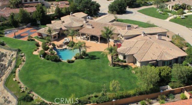 Beautiful custom one-story Mediterranean estate with panoramic pastoral views. Located at the top of the Estates At The Oaks, on a quiet cul-de-sac, and featuring a wonderfully private 2+acre lot with resort style beach entry pool/spa with slide & grotto, barbecue center, large sports court, covered patios, fire pit, and rolling lawns. Amenities include a big chef's kitchen that opens to the family room, large master suite with stone bath, plus home theatre, game room, sports bar, wine cellar & tasting room, office/library, gym with steam, sauna, beauty parlor, massage room, bonus room, living & dining rooms, and garages for five cars. Additional features include stone and hardwood floors, open beam volume ceilings, sound system, video security cameras, outdoor fireplace, and lush landscaping. Superb current area comps too!