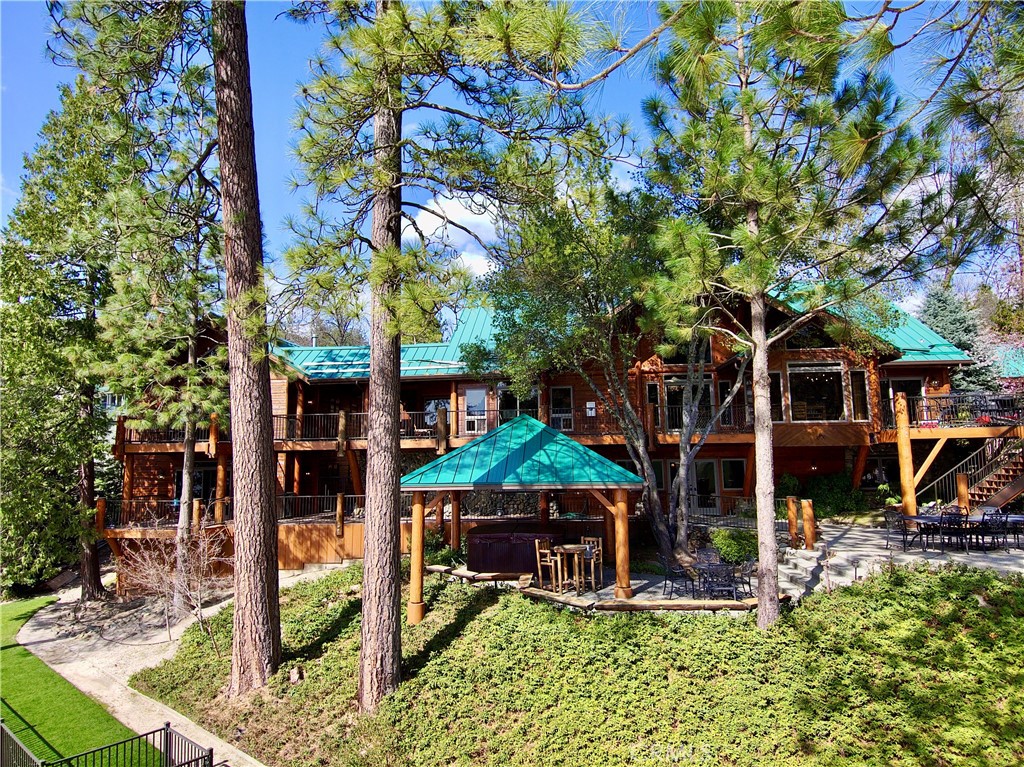 This is a rare opportunity to own The Bass Lake Lodge, originally built by ED Hardy. The logs were harvested from Hardy's Ranch called Hazel Green in Yosemite. This amazing property has so much: private dock, huge garage, boat house recreation room, gym, decks, patios, gazebo, generator, two great rooms, two bars, wine cellar, office, laundry room, ice maker room, lake views everywhere. Five bedrooms have their own private bath, two of them are private suites. Located at the Pines Village on Bass Lake, about a 25 minute drive to the entrance of Yosemite National Park it is easily one of the most wonderful areas in the world. Virtual tour available but you must see this rare property to fully appreciate it. Shown to qualified buyers by appointment only.