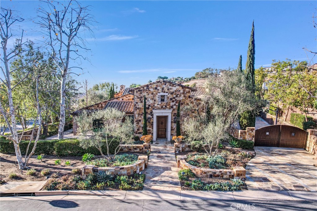 PRICE REDUCED! This exceptional custom home features five en-suite bedrooms, all located on the ground floor, in Shady Canyon community is a true masterpiece. Located on a prime corner lot within the renowned golf club enclave in Irvine, this home offers unparalleled elegance and style. Set against a backdrop of rolling pastoral hillsides, the stunning Tuscan-style architecture is perched on a spacious 26,000-square-foot lot. Inside, the home boasts 5,500 square feet of thoughtfully designed living space. Highlights include a living room, large family room and a gourmet chef’s kitchen. The wine cellar, exercise room, and an office located upstairs (the only structure on the upper level) offer additional functionality. The ground-level main suite features its own fireplace, a large bathroom, and a walk-in closet. The home includes a four-car garage with ample parking. Outdoors, the property is equally impressive, with a 25-meter infinity lap pool and spa, an outdoor BBQ, fireplace, and fire pits. The Shady Canyon association provides access to tennis courts, pickleball courts, a pool and spa, and scenic outdoor seating areas. The community is gated with two separate guard entrances. Conveniently located just a short drive from Spectrum shopping center, Laguna Beach, Newport Beach, and a variety of dining, shopping, and entertainment options, this home is also close to major freeways, hiking trails, and the Shady Canyon, Strawberry Farms, and Oak Creek golf courses. It’s within the highly regarded Irvine school district. Type the address into YouTube to watch the movie.