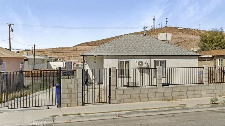 Welcome to this  2-bedroom, 1-bathroom home, offering 727 sqft of comfortable living space. This property features a new iron and brick fence, fully enclosing the yard for enhanced privacy and security. Stay comfortable year-round with Central Evaporative Cooling. Inside, you’ll find a bright and open floor plan with laminate flooring throughout, creating a seamless flow from room to room. The modern kitchen boasts appliances, sleek white and gray quartz countertops, and a spacious layout with plenty of cabinet space. Large windows flood the home with natural sunlight, enhancing the warm and inviting atmosphere. The stylish bathroom features a tiled bathtub and continues the home’s consistent design with laminate flooring. Additionally, the laundry area is conveniently located in the kitchen. Step outside to the spacious 7,800 sqft lot, offering ample room for RV parking, off-road toys, or space to create your own outdoor oasis—perfect for outdoor enthusiasts or those needing extra space for hobbies. The property features front and back door access with a private driveway and gated parking. Conveniently located near schools, shopping, and restaurants, this home offers both comfort and accessibility.