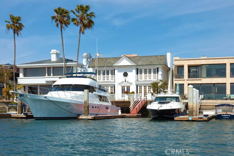 This Linda Isle bayfront “Gold Coast” home is likely the finest view property to come on the market in the last decade. Located four homes from the Southwestern tip of Linda Isle, the property features spectacular unobstructed vistas of Newport Harbor’s main turning basin; from this location you have front row seats to morning crew workouts, all of the harbor’s activities, sailing regattas and breathtaking evening sunsets. This Regency Style home features over 5,400 square feet of living space, stunning paneling and mouldings, nicely proportioned rooms and ceiling heights, six fireplaces, an elevator, a large living room with a fireplace, an elegant bar, family room with a fireplace and bookshelves, a formal dining room and a handsome den. Upstairs there are 4 bedroom suites highlighted by two waterfront masters with fireplaces and big baths. The home has 50’ of waterfront with one of the largest deep water private docks in the harbor and can accommodate a boat up to 81’ and several side-ties. Linda Isle is a private 24-hour guard gated island of 107 waterfront homes and features a private tennis court, beach club, and kids play area. Opportunites abound, you may live in the home as-is, remodel or redevelop the property to create the home of your dreams.