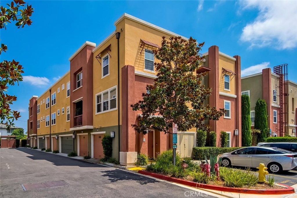 Turnkey Tri-level Townhouse in the heart of Garden Grove. The Lotus Walk Community is meticulously maintained. This 2 bedroom, 2.5 bath end unit sits in a premier location in the center of the community providing security and ease of access. From your private front entrance or your direct access 2 car garage, you'll enter and enjoy the custom paint, luxury vinyl flooring, and premium grade carpet. As you enter the open concept floorplan on the main level you'll be greeted by the many large living room windows pouring in natural light. The kitchen boasts stainless steel appliances, white cabinets, and granite counter tops, and upgraded recessed lighting. The private balcony is perfect for a barbecue, plants, or a place to enjoy your morning coffee. The half bathroom / powder room is conveniently located on the main level with a pedestal sink and brand new faucet. The bedrooms and laundry are located on the top floor. The washer and dryer sit side-by-side and are tucked conveniently into the large hallway closet with cabinets and additional space for storage. The large Master Bedroom has a custom designed walk-in closet, and dual sinks with new faucets and drains. The second bedroom has its own full bath and large closet. This loved home is only minutes away from Disneyland, Downtown Disney and the Garden Walk. There are so many delicious restaurants nearby, easy freeway access and the Haster Basin Park is only a few minutes walk away.