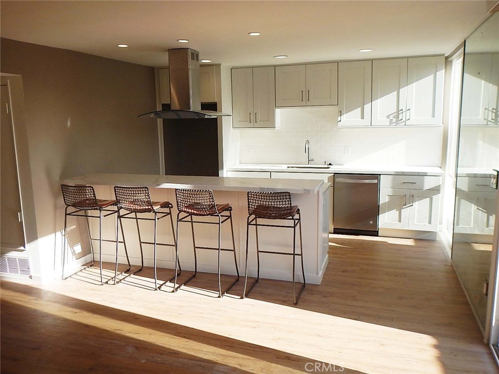 Newly remodeled 2 Bed/1Ba unit with new wood floors, new paint, new cabinets and new quartz counters. The remodeled kitchen has stainless steel appliances, a breakfast bar (with four barstools included), quartz counters and opens to the family room. The family room has a stacked ledger stone fireplace with rustic wood mantle along with a cannonball décor fire-kit. TV brackets for flat screen are already attached to the wall in both bedrooms and will be installed above the fireplace in the living room. The remodeled bathroom has dual sinks, a Carrera marble throughout, a pebble shower floor, new cabinets and quartz counters. There's one deck and one enclosed, private porch. Included, is a shared garage (one space & storage) and one carport. Community laundry room. Within walking distance to Corona del Mar village and a community pool. This unit does not back PCH, there's no road noise.