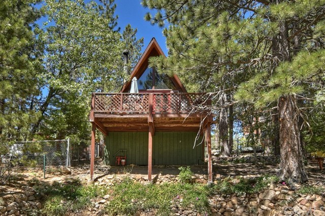 The quintessential A-Frame-an all time fan favorite! Tucked away on a quiet little cul-de-sac In Arrowbear, this special cabin is the adorable and affordable retreat you've been waiting for. The main level features the living room with open beam ceiling, rock fireplace and dining area, kitchen, bedroom and full bath with laundry hookups. From this level there are two decks to enjoy-one in front and one in back. The kids will love the upstairs loft accessible via a sturdy ladder adding to the mountain fun and adventure! To make it even sweeter, it comes fully furnished and ready for you to walk in and enjoy! The community offers a small lake, ball field and park and is just 4 miles from Snow Valley Ski Resort!