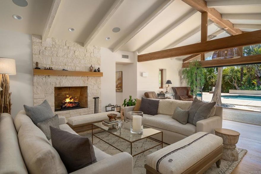 Awake to each and every day as if you're on vacation at this private and serene paradise in Rancho Santa Fe's exclusive Covenant, where the indoors blends with the out, and tranquility and style greet you at every turn. Completely remodeled in 2018, the home has been transformed into an enviable residence with five ensuite bedrooms and five and one-half baths in approx. 5,357 s.f.—all on one open and inviting single level. Fold-away walls of glass, high ceilings and an abundance of windows lend a bright, airy vibe to the open floor plan and allow for seamless enjoyment of luxurious San Diego's renowned climate and lifestyle. Tropical grounds reveal exotic palms and fruit trees, a pool with raised spa, two outdoor fireplaces, a pizza oven, BBQ, and a separate casita with bath. Easily flowing from room to room, the interior displays European white oak flooring throughout, a clean color palette and rustic beams. Public spaces generously accommodate entertaining and casual daily living with a chef-inspired kitchen and a dining room with built-in seating. Offering a private retreat, the reimagined primary suite presents high ceilings, a spa bath with rear yard access, and a sitting area with tranquil views of the grounds.