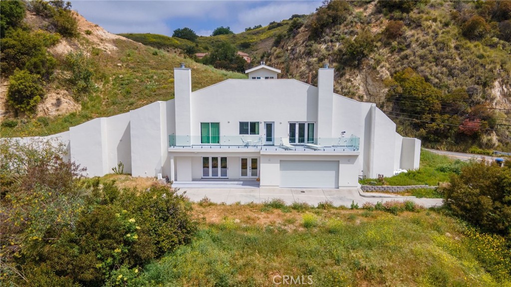 Amazing Rental opportunity awaits! New Build, Amazing home, One of the most unique and eco-friendly homes in Los Angeles County. This dome home is built into the hills with beautiful mountain and canyon views. The home is extremely sustainable and highly resistant to earthquakes, fires and floods. Master has stunning views, fireplace, balcony, and large walk-in closet as well as 2 additional closets. Master bath with soaker tub and separate shower wired for steam. Two additional bedrooms upstairs, both with views. Kitchen with center island, 3 sinks, dual source oven, with pot filler, and huge walk-in pantry. Theater room/family room with bathroom.