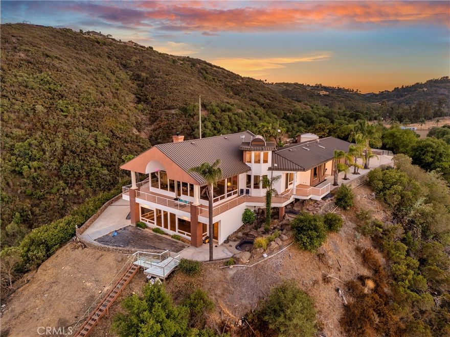 One-of-a-kind estate with amazing sunrises and shimmering nighttime city light views.
The best view property in DeLuz. Priced way below licensed appraiser estimate. ASK
THE LISTING AGENT ABOUT SELLER FINANCING !! HIGHLY SECURE PROPERTY
with 10 ft. entry gates and iron perimeter fencing. EXISTING RENTAL INCOME.
Property has 2 HOMES on 23 PRISTINE ACRES that are only 7 minutes to both Old
Town Temecula and Murrieta. Main home is 5,050 sq. ft. with 24 ft. ceilings in living
room, 4 bedrooms, 4 baths. A 800 sq. ft. entertainment / gym area with views. Both
homes are fully remodeled. Second home is 1,560 sq. foot with 3 bedrooms and 2
baths with city views. Second home accessibility has a wheel chair ramp. Each home features Viking appliances and new HVAC. Low-cost
maintenance and utilities. Self-sustaining trees and vegetation. Perfect property for
horses, additional homes or your own winery. No neighbors. Property has a rare 2-
inch agriculture water meter line if needed. Low cost CA Fair Plan Insurance due to structural design features. Excellent investment upside appreciation
potential !!