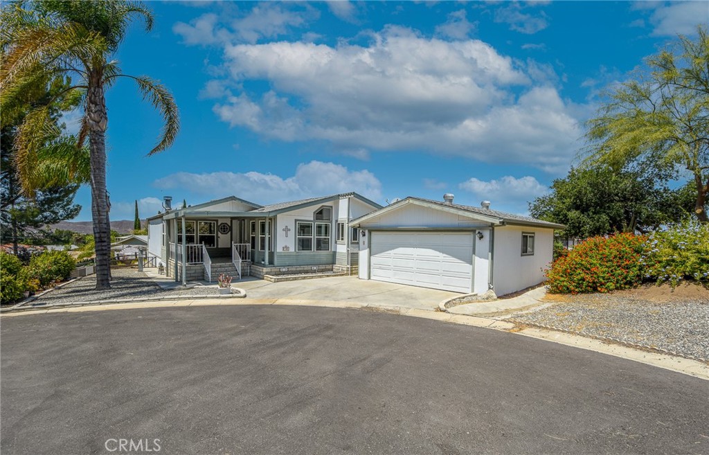 Pride of ownership at its Highest level !!!!....Beautiful TRIPLE WIDE mobile home in a quiet Cul-de-Sac lot at Saddleback. Great views to mountains and to the valley from every angle of this beautiful property.. This is an ALL AGE, gated and FAMILY friendly mobile home park. This mobile home features three bedrooms and two baths with very well kept, over 1600 sqft of living space. As you enter into this property a spacious living room with hardwood flooring, high ceilings and an strategically located cozy fireplace will welcome you. To the right, a gorgeous chef's kitchen is located. It displays, beautiful counter tops, earth tone backsplash, lots of cabinetry for storage and it is open to the dining room with great views and plenty of natural lighting. Perfect to enjoy nature while enjoying a cup of coffee!. Master bedroom is very spacious. Dual sinks in master bathroom, walk-in shower and a separate tub are there for you to enjoy as well. All rooms are spacious. In the outside, a separate two car garage, storage shed, lost of green vegetation including bushes flowers and nicely landscaped all around it. This community is located within walking distance to schools, shopping centers, grocery stores, DMV, banks and for commuters quick access to Domenigoni Pkwy. Amenities offered include a recently renovated gated pool and spa, a recently added play ground, billiard room, basketball court, a library, RV and boat storage. There are too many good things about this property to cover them all...come on by, take a look and make it yours!!!