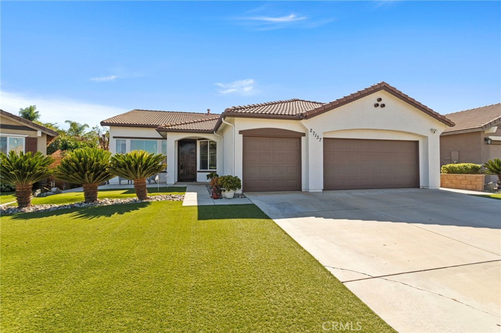 Beautiful Single Story Pool Home nestled on a quiet street in the Menifee Valley Ranch neighborhood.  There are so many wonderful features in this 4 bedroom home designed for entertaining and comfortable living with its spacious and open floor plan.  Right away you will notice the drought friendly landscape with your own personal 3-hole putting green on grass turf. The living room and dining room have high ceilings letting in abundance of natural light. In the chef's kitchen opening up to the family room, you have granite countertops, touchless faucet, large kitchen island with large basin sink, and plenty of storage. Family room offers cozy fireplace. In your private backyard oasis enjoy many features...the sparkling pool with waterfall and a Baja shelf to lounge in, BBQ island with firebowl, patio cover with ceiling fans and mounted tv. Large master bedroom has black out curtains and master bathroom with custom built spacious walk-in shower.  Additional features are 3 car garage, leased solar, smart home thermostat, THX surround sound and more.  This community is close to shops, restaurants, freeway, biking and hiking trails.