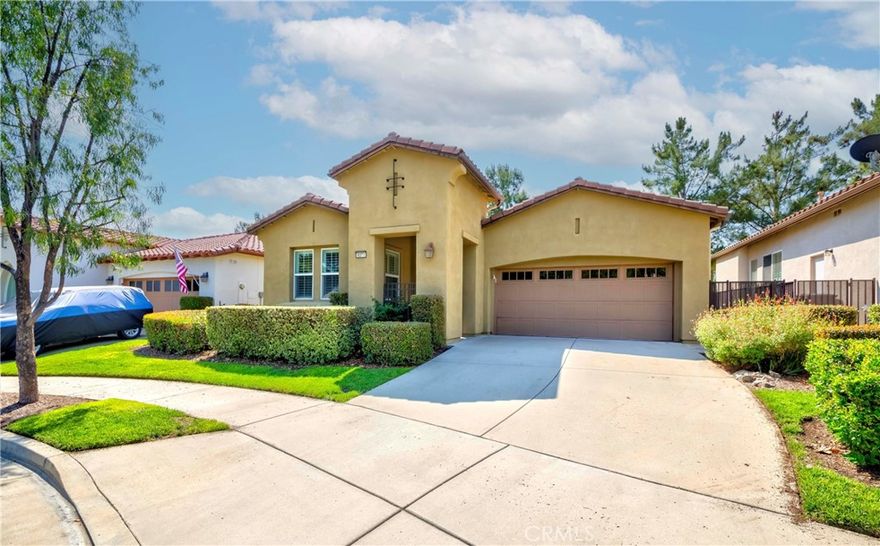 Welcome to this stunning, upgraded home located in the prestigious 55+ gated community of Trilogy at Glen Ivy, Southern California’s premier active adult neighborhood nestled at the base of the Cleveland National Forest. This beautifully maintained single-story residence offers an open and airy floor plan with high ceilings, upgraded laminate flooring, fresh paint, crown molding, and baseboards throughout. The heart of the home is a spacious great room that flows effortlessly into a gourmet kitchen, featuring corian countertops, an oversized center island with breakfast bar, extended cabinetry with decorator glass doors, and a charming breakfast nook that opens to a covered outdoor patio perfect for relaxing or entertaining.

The private primary suite is a true retreat, sliding doors to a separate patio area, a generous walk-in closet with built-in shelving and cabinets, and an en-suite bathroom with plenty of storage space. A secondary bedroom and full bathroom are situated away from the main living areas, providing comfort and privacy for guests. Additional highlights include a formal entry with a custom designer front door, a cozy formal dining room, new ceiling fans, an epoxied garage floor, and upgraded technology wiring throughout. The backyard offers pick-a-boo view of the mountains, adding to the peaceful ambiance of the home. Residents of Trilogy at Glen Ivy enjoy access to an array of resort-style amenities, including championship golf, tennis courts, two heated swimming pools, a state-of-the-art fitness center, walking trails, Glen Ivy Spa, a full-service clubhouse, and a variety of clubs, classes, and social activities. This home is the perfect blend of comfort, style, and vibrant community living.