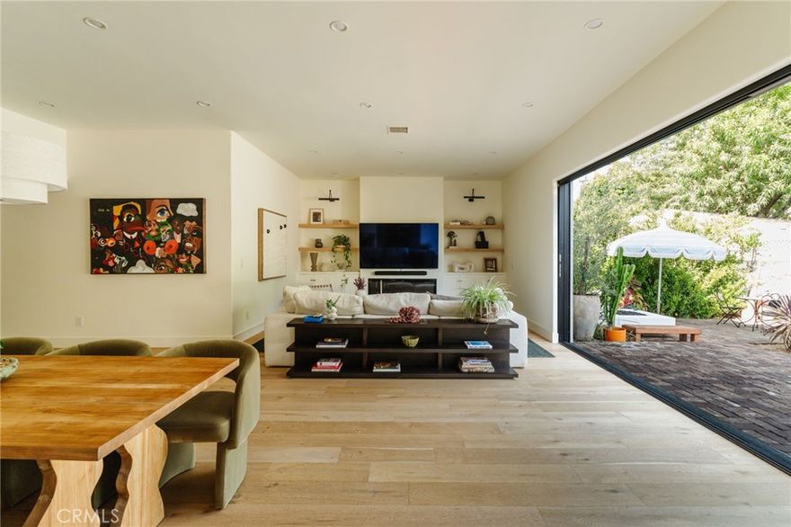 Tucked away in a prime Sherman Oaks neighborhood, this contemporary Mediterranean estate has been fully updated, blending sophisticated designer finishes with unique and personal touches. Designed by notable Architectural Digest Top 100 interior designer, Mandy Cheng, this property is a statement. 



Upon entering, you’re greeted by double doors that lead into a grand foyer with soaring double-height ceilings, setting the tone for the home’s spacious and inviting atmosphere. One of the home’s standout features is the formal living space/library room, designed to offer a peaceful escape. It houses custom-built shelves and nooks for reading, making it the perfect space for relaxation and creativity.



The open-concept main living space includes a family room with a sleek fireplace surrounded by custom built-ins, stunning warm colors, a beautiful chef’s kitchen outfitted with top-of-the-line Viking appliances, and both formal and informal dining areas perfect for hosting family and friends. With floor-to-ceiling glass doors that pocket, this creates the perfect indoor-outdoor entertainment space, flowing into your nearly 8,000 square foot lush backyard. The first floor also includes a laundry room, a bedroom, a full bathroom, and a powder room. Upstairs, you’ll find two luxurious primary suites. The larger of the two features an intimate fireplace, private balcony, spacious walk-in closet, and a spa-like bathroom complete with a soaking tub, rainfall shower system, and double vanity. Additionally, two generously sized bedrooms with custom closets offer ample space for family or guests.