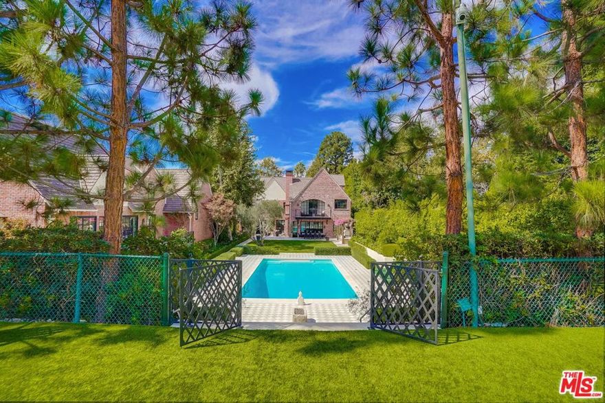 Breathtaking One-Of-A-Kind Estate! Over 13,300 square feet of exquisite living space on a gated, private, nearly 1 acre, rare tennis court lot on the most prestigious block in true Hancock Park! Main 4 story house has 6-7 bedrooms,10 luxury baths, a top floor theater & office, a fabulous library/informal living room, and basement-level huge multipurpose room with windows/french door to the exterior! Primary with fireplace and balcony overlooking rear yard includes 2 expansive, walk-in dressing room/closets and 2 separate new designer marble bathrooms (one with extra laundry closet). New gourmet kitchen with walk-in pantry and family room overlooking rear patio, pool, outdoor kitchen with pizza oven and lush grounds. Staff or guest quarters over 3 car garage PLUS additional guest room and bath off vaulted ceiling Great Room in pool house . Featured in Architectural Digest! A Very Rare Find and easy to show to qualified buyers!