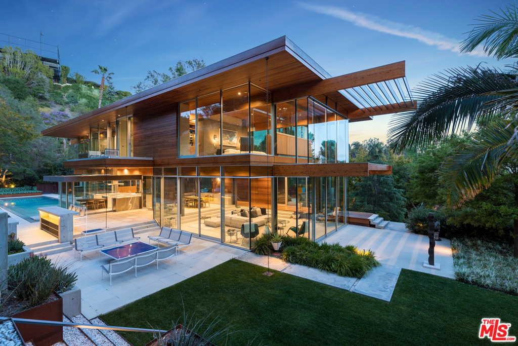 Designed by one of California's greatest architects, Ray Kappe, this stunning and extremely private 3 level masterpiece is his finest work. Built in 2017, this gorgeous architectural in the City of Beverly Hills sits on approximately 30,000 square feet of land with an oversized flat pad that includes large grass lawns, expansive patios, an outdoor kitchen, entertainment area, guest house, pool house, swimmers pool, and a viewing deck overlooking the city, canyons, and ocean. A seamless indoor and outdoor floor plan features Kappe's quintessential use of poured-in-place concrete, teak, redwood, and walls of glass. The main house amenities include a custom Bulthaup kitchen, gym, theater, tempered wine cellar, all glass elevator, and 3 car garage, while the gorgeous master suite has 2 private decks, views to the ocean, a vanity area, and dual walk-in closets. Showings to prequalified buyers only.