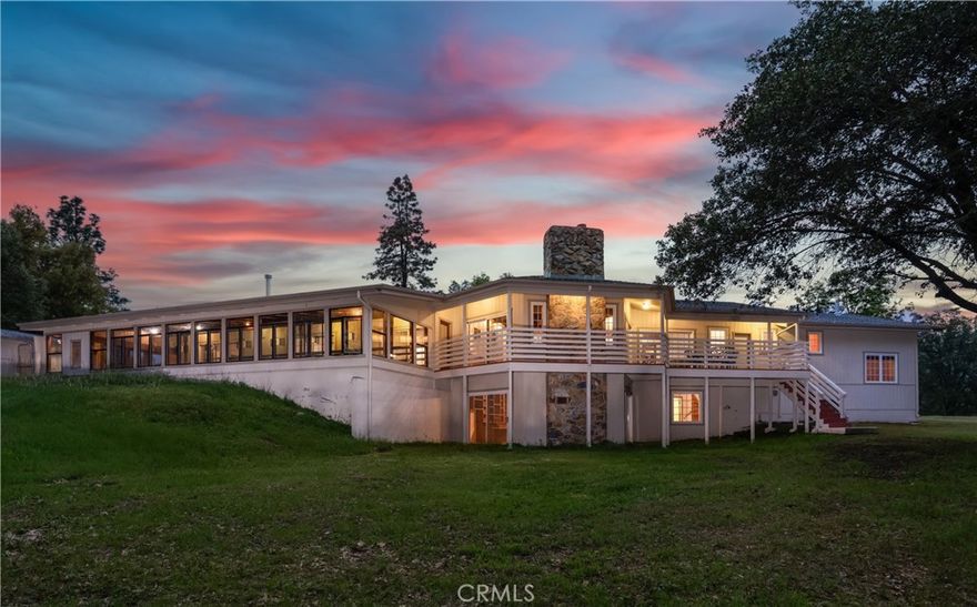 This outstanding custom built home has so many unique qualities and beauty, it is a must-see mountain gem. Bosting over 3,000 sf of living space on over 10 acres that runs into the Lush Meadows pond, Dawn Lake (but is outside of the association). Circular driveway, double door entry & gorgeous mountain views from all around. Large 4 stall horse barn that could alternately be the perfect game room if you’re planning on making this a short-term rental (home is ADA compliant & turn-key for a primary residence, vacation home or STR), fenced garden area, horse arena & fenced dog run. This home radiates quality & craftmanship with a large master suite featuring vaulted beamed ceilings with tongue & groove, wood stove, his & her sinks & closets with access to the indoor pool & spa from every bedroom. Jetted guest tub, large walk-in pantry, formal dining, grand Livingroom with a statement rock fireplace & decks for summer nights & entertaining. There is a studio with sink & fridge hookup + more closet space, this could be the perfect office or another bedroom with a wood stove and its own entrance. Downstairs from the kitchen is the library/bedroom/family room/office with a bathroom and its own cozy rock fireplace. This is your mountain retreat, close to Yosemite, the beautiful town of Mariposa or a short drive to Oakhurst for your conveniences. Hiking, biking, paddleboarding, kayaking, fishing… it’s right outside your door.