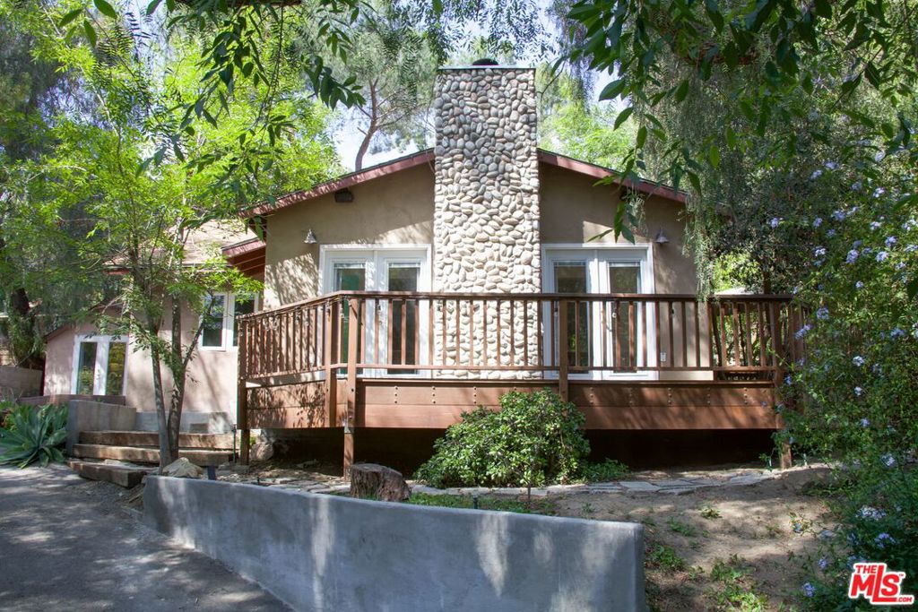 Introducing 10608 Johanna Avenue, an updated home and horse property located in the premium Shadow Hills neighborhood. Upon ascending a long, private driveway lined with mature trees, an electric gate opens to reveal the home's serene entrance with a statement stone chimney. Designed for an indoor outdoor lifestyle, French doors expand the living, dining and bedroom toward a wrap-around deck immersed in greenery. The living room's natural light and gas fireplace creates an inviting atmosphere throughout the day and into the evening, while the kitchen's modern charm features Samsung appliances including a smart gas range, fridge and dishwasher, along with a farmhouse sink, detailed backsplash and Dutch door. Additional highlights include central heating and cooling with Nest thermostat. The property's detached structures offer a second bedroom with mini split heating and cooling, Castlebook Barn, large storage area, and chicken coop. In balancing both a calm, rural community with urban convenience, residents of Shadow Hills enjoy one of Los Angeles' most diverse outdoor lifestyles with immediate access to horse trails, hiking, water recreation, golf and more while situated only 6.5 miles from the Hollywood Burbank Airport and 8 miles from Burbank's city center. It is also among the few remaining equestrian-zoned communities in Los Angeles as well. Stretching across a tiered 0.45 acre lot, the property offers rare, flexible access from both Johanna Avenue to the west and McBroom Street to the east.